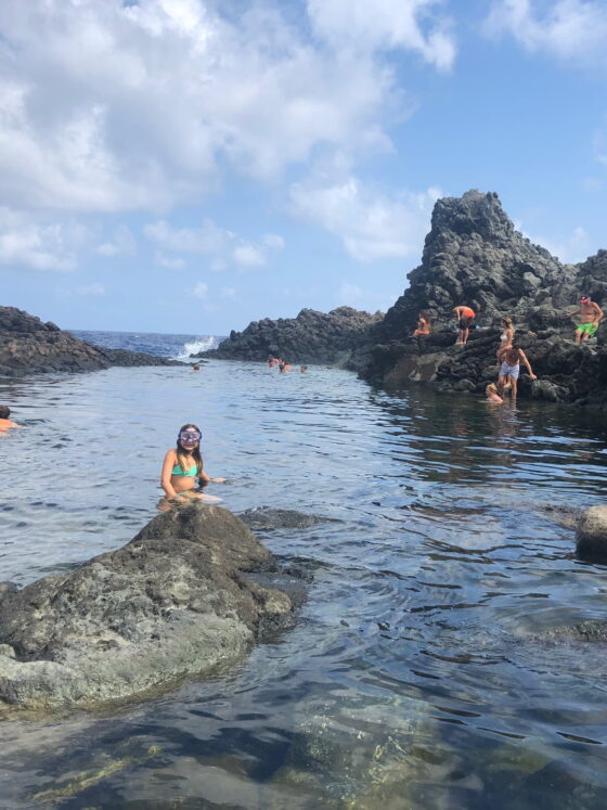 child swimming at rocky beach