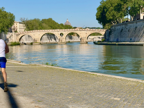 Runner by a river and bridge